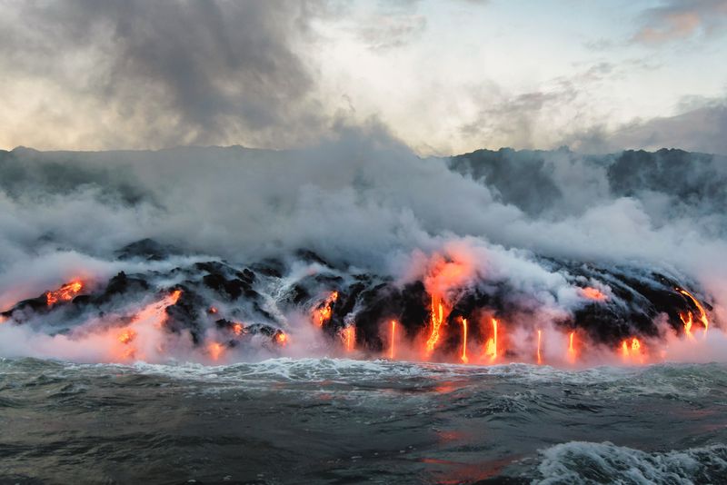 Molten lava flowing into the Pacific Ocean on Big Island of Hawaii. 
