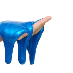 A close up of a person's hand holding blue slime in their hand. The slim is glooping over their palm and starting to drop to the the floor. The hand is set against a white background. 